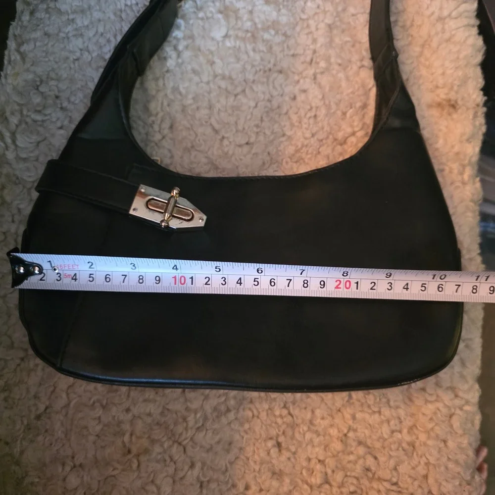 Minimalist black hobo shoulder bag gold hardware under arm‎